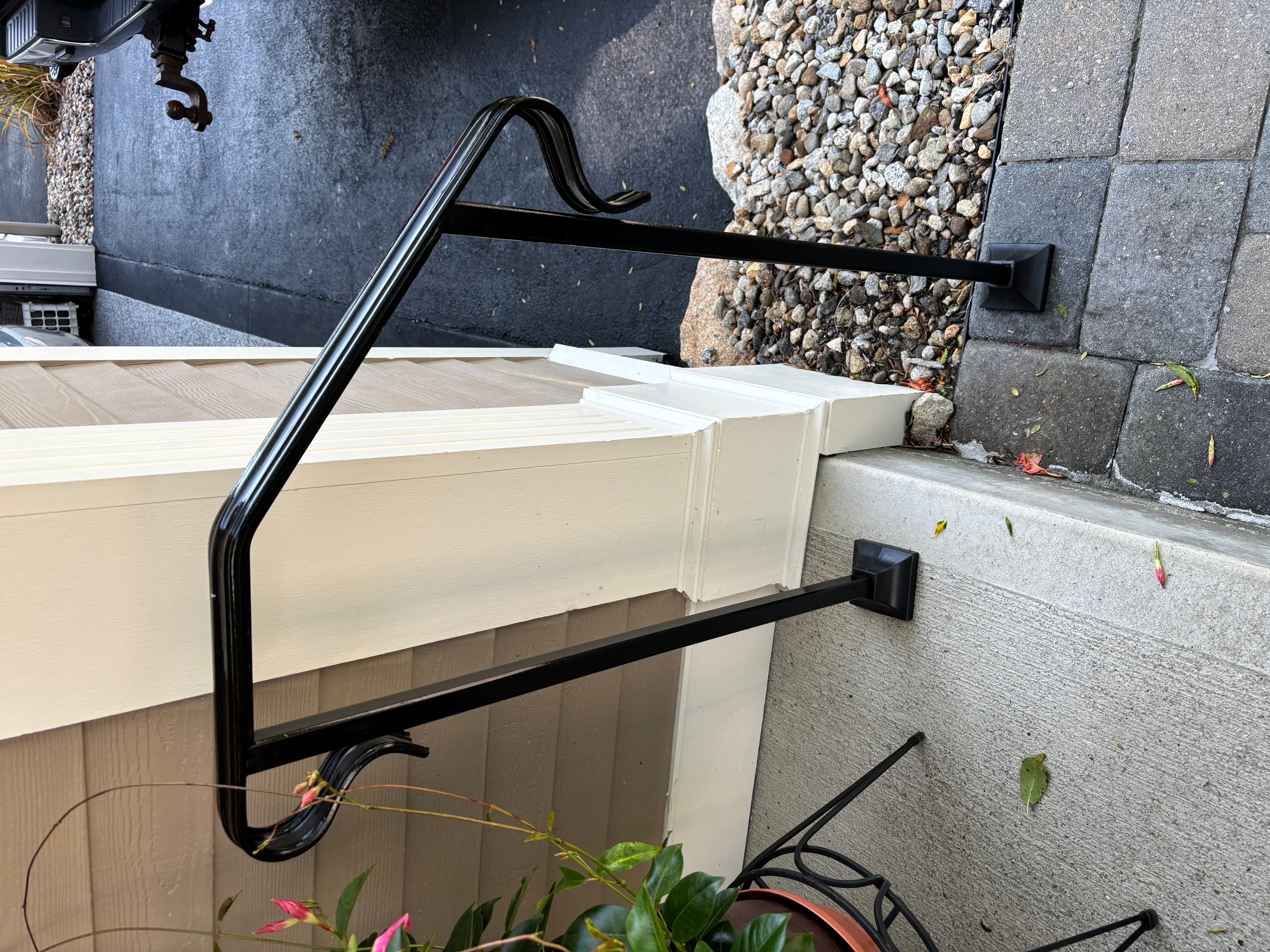 Black powder-coated welded handrail at residential entry