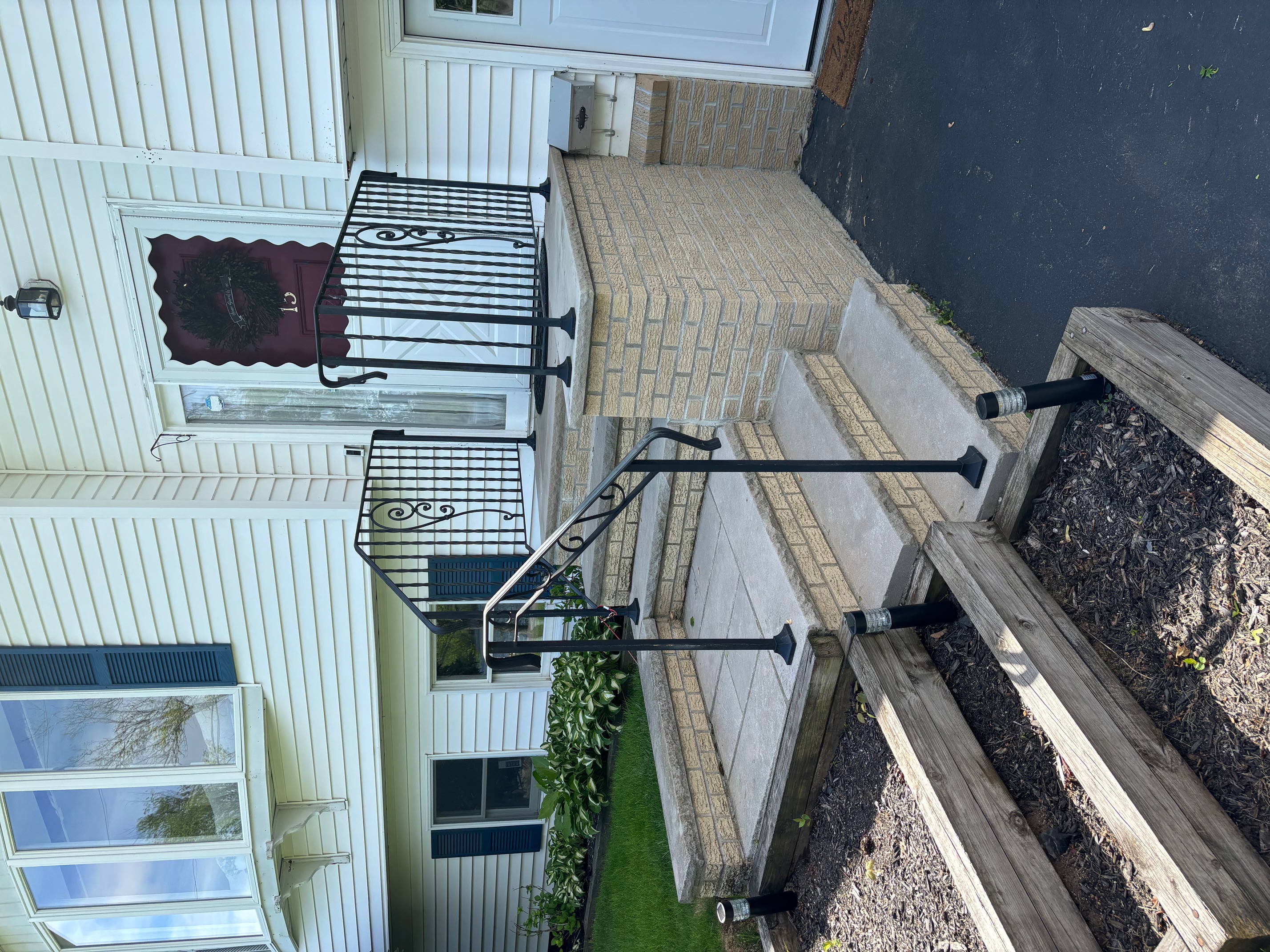 Wrought iron style welded porch railing with scrollwork